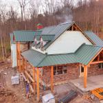 View of roof, cedar beam details and cultured stone exterior